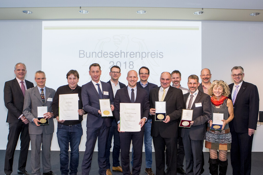 Ministerialrat Dr. Michael Koehler (BMEL) (l.) überreicht gemeinsam mit DLG-Vizepräsident Dr. Diedrich Harms (r.) Urkunden und Medaillen an die ausgezeichneten Betriebe.