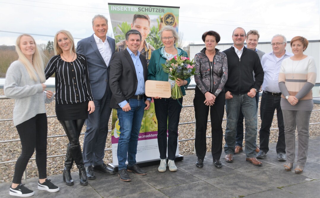 Reinhard Vinkmann (3.v.l., Geschäftsführer Deflex Dichtsysteme GmbH), Oliver Steinmetz (4.v.l. Verkaufsleiter), Jörg Schmitz (3.v.r., Geschäftsführer schmitz medien & design) und das gesamte Team (Sparte Insekten Sonne Sicht Pollen SCHUTZ) gratulieren Barbara Cott (5.v.l.) zu ihrem Gewinn beim Wettbewerb „Insektenschützer 2019“